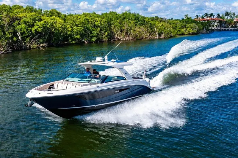 Slide: The Image of 2019 Sea Ray SLX 400 Outboard cruising on a scenic waterway. - 16