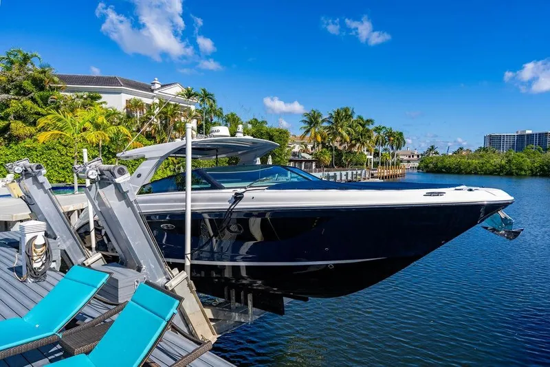 Slide: The Image of 2019 Sea Ray SLX 400 Outboard docked by tropical waterfront with blue sky. - 21