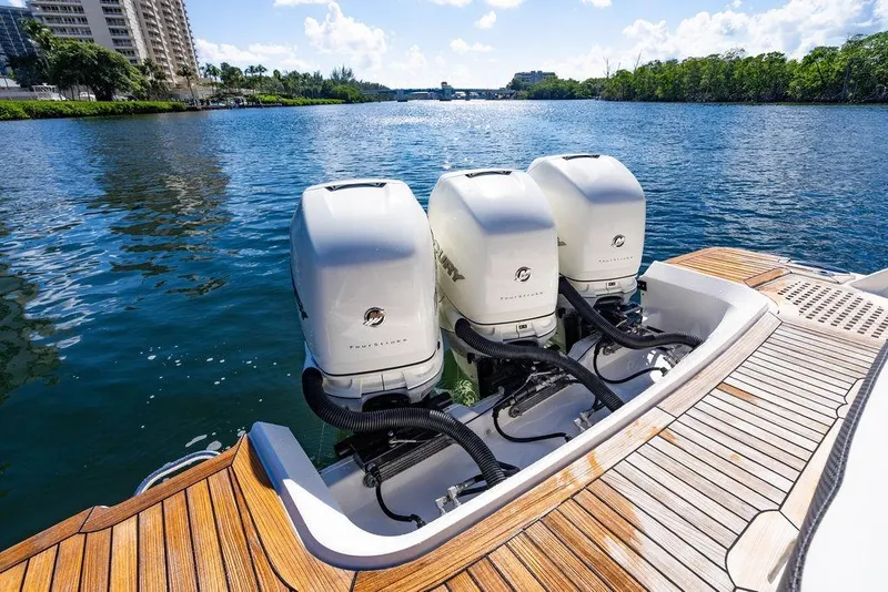 Slide: The Image of 2019 Sea Ray SLX 400 Outboard with triple engines on a sunny waterway. - 25
