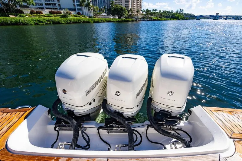 Slide: The Image of 2019 Sea Ray SLX 400 Outboard with triple Mercury engines on a sunny waterway. - 26