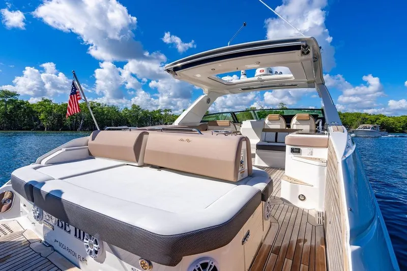 Slide: The Image of 2019 Sea Ray SLX 400 Outboard luxury boat on a sunny day, featuring spacious deck. - 27