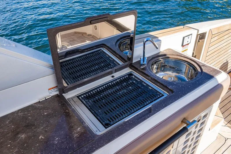 Slide: The Image of Outdoor kitchen on 2019 Sea Ray SLX 400 Outboard yacht with grill and sink. - 33
