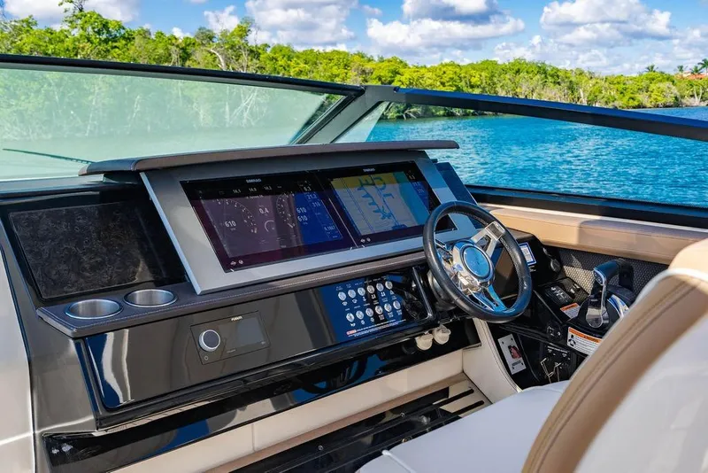 Slide: The Image of 2019 Sea Ray SLX 400 Outboard helm with modern navigation displays and controls. - 37
