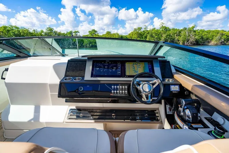 Slide: The Image of 2019 Sea Ray SLX 400 Outboard helm with modern controls and scenic water view. - 38