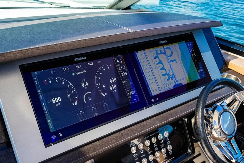 Slide: The Image of 2019 Sea Ray SLX 400 Outboard dashboard with dual Simrad displays and steering wheel. - 39