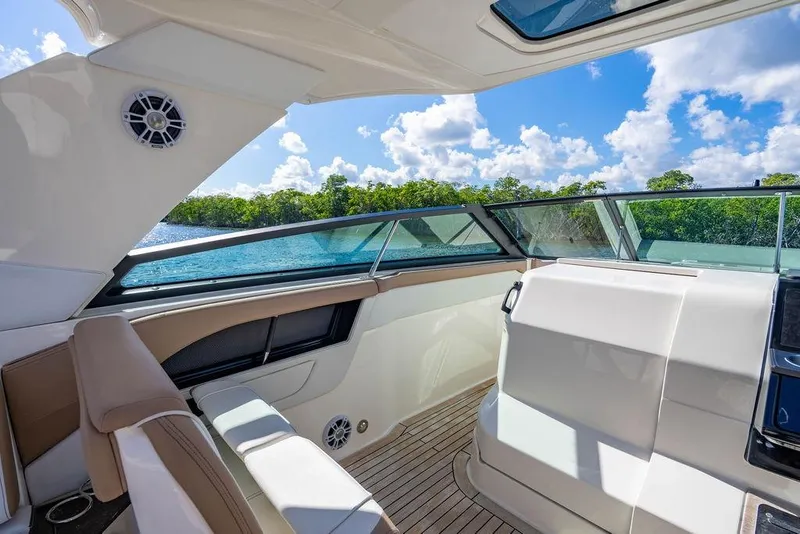 Slide: The Image of Interior view of 2019 Sea Ray SLX 400 Outboard boat with scenic water backdrop. - 45