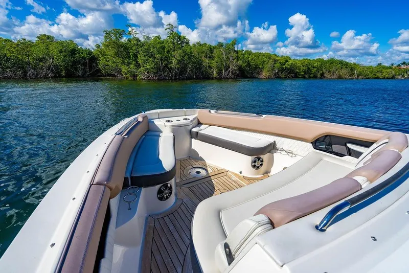Slide: The Image of 2019 Sea Ray SLX 400 Outboard boat interior with luxurious seating, on a sunny day. - 46
