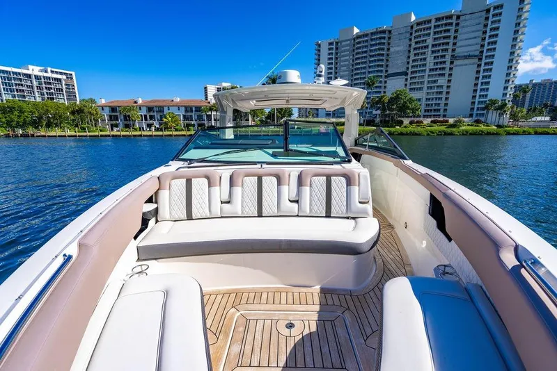 Slide: The Image of 2019 Sea Ray SLX 400 Outboard boat with luxurious seating, docked near waterfront buildings. - 47