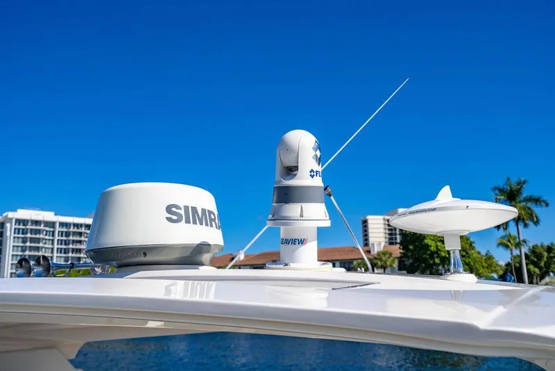 Slide: The Image of 2019 Sea Ray SLX 400 Outboard with advanced navigation equipment under clear blue sky. - 48