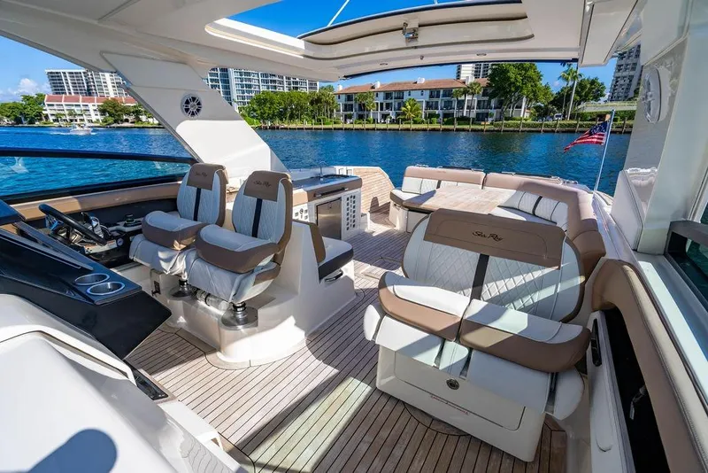 Slide: The Image of 2019 Sea Ray SLX 400 Outboard luxury boat interior with plush seating and scenic waterfront view. - 50