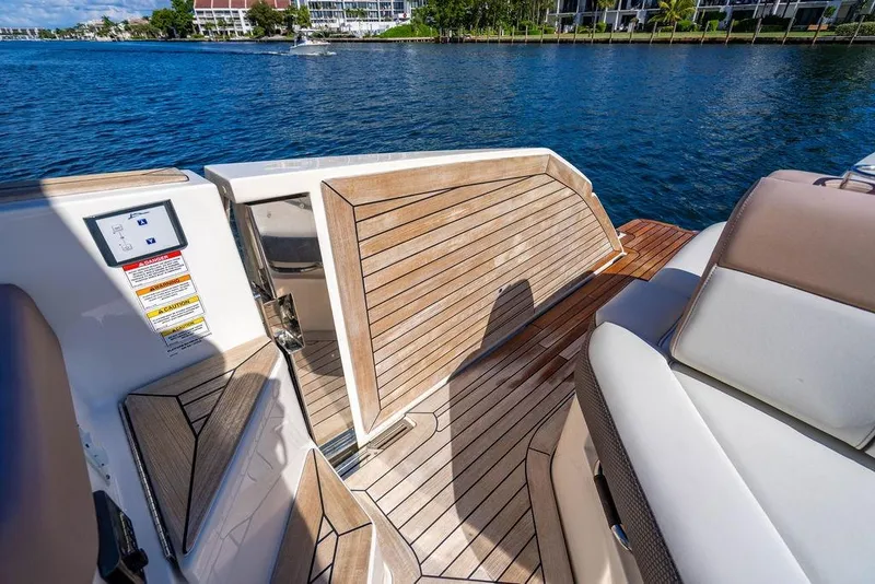 Slide: The Image of 2019 Sea Ray SLX 400 Outboard boat interior with teak flooring and luxurious seating. - 52