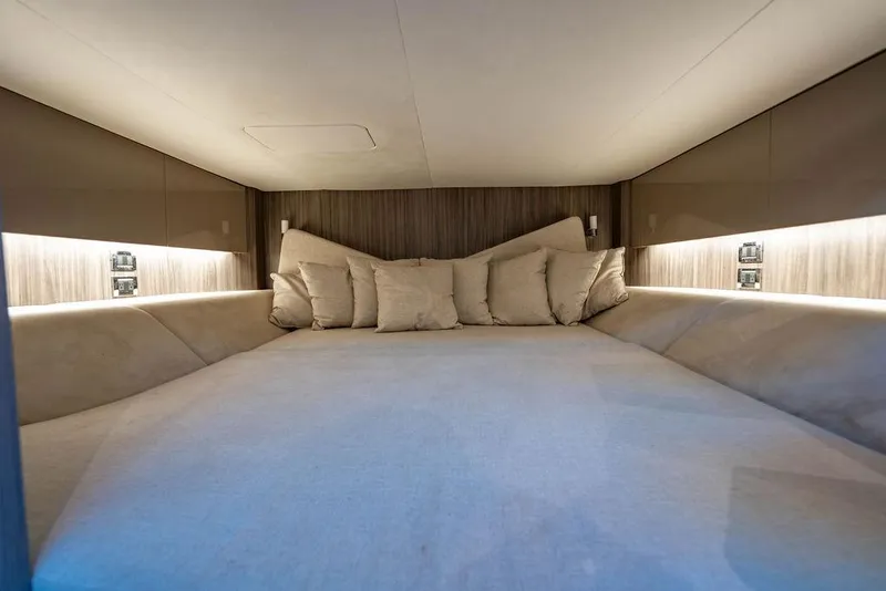 Slide: The Image of Luxurious cabin interior of 2019 Sea Ray SLX 400 Outboard with plush bedding. - 54