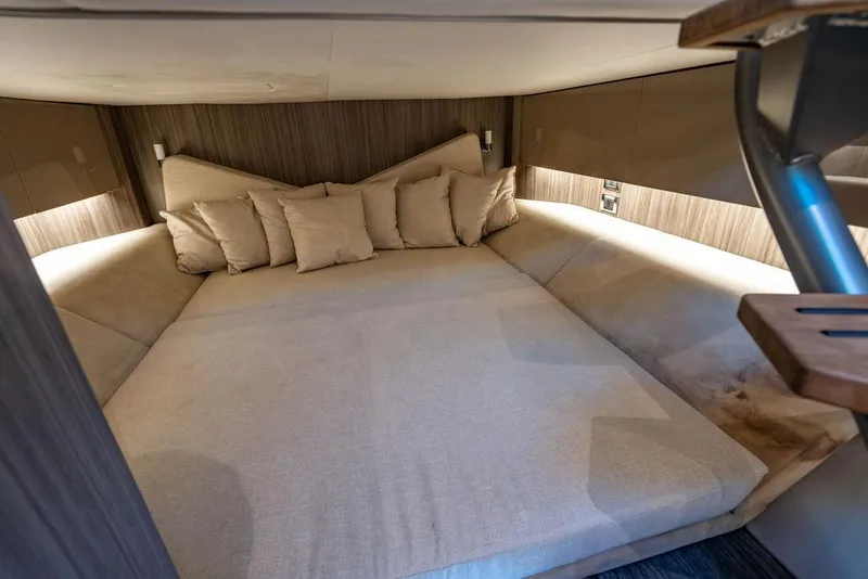 Slide: The Image of Luxurious cabin interior of 2019 Sea Ray SLX 400 Outboard with cozy bedding and cushions. - 55
