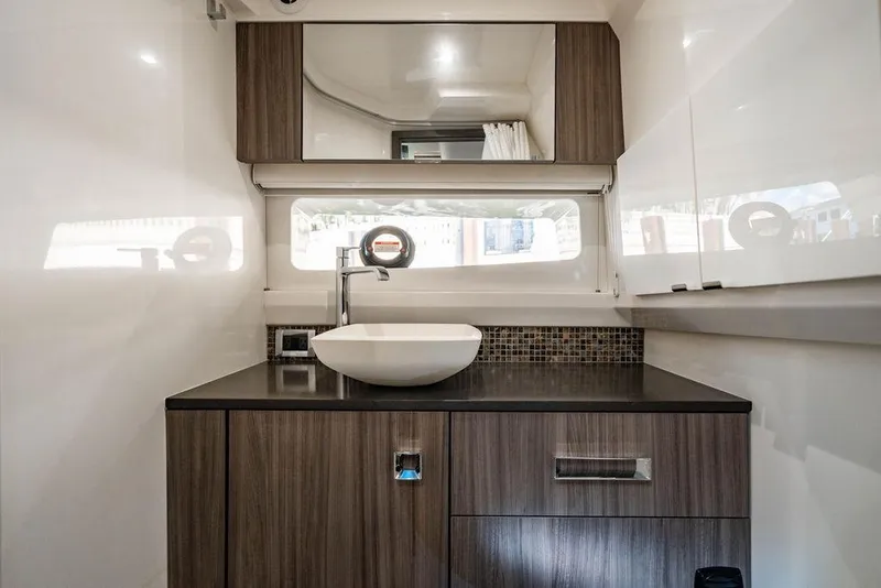 Slide: The Image of Luxurious bathroom interior of 2019 Sea Ray SLX 400 Outboard yacht, featuring modern sink and cabinetry. - 58
