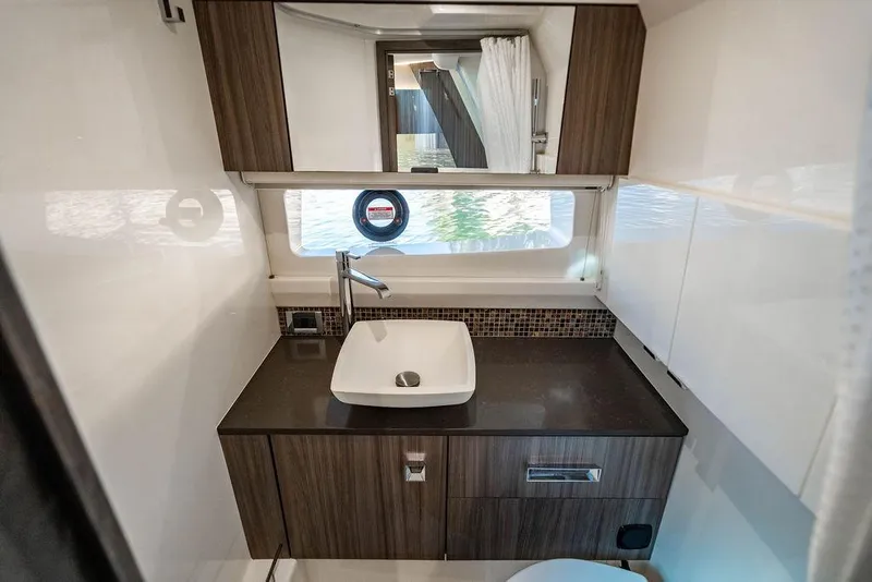 Slide: The Image of Luxurious bathroom interior of 2019 Sea Ray SLX 400 Outboard yacht with modern sink and cabinetry. - 59