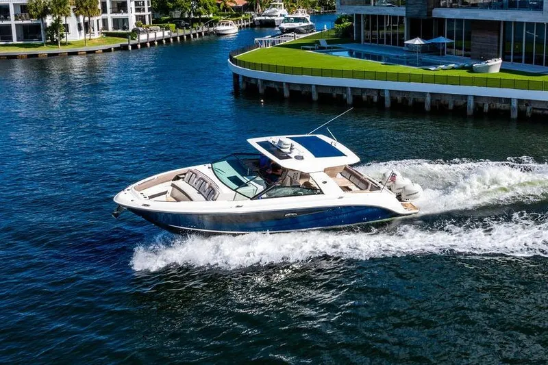Slide: The Image of 2019 Sea Ray SLX 400 Outboard cruising on a scenic waterway. - 6