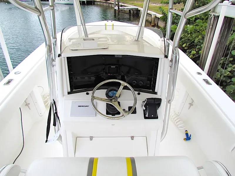 Slide: The Image of 2005 Venture 34 Open boat helm with steering wheel and controls. - 5
