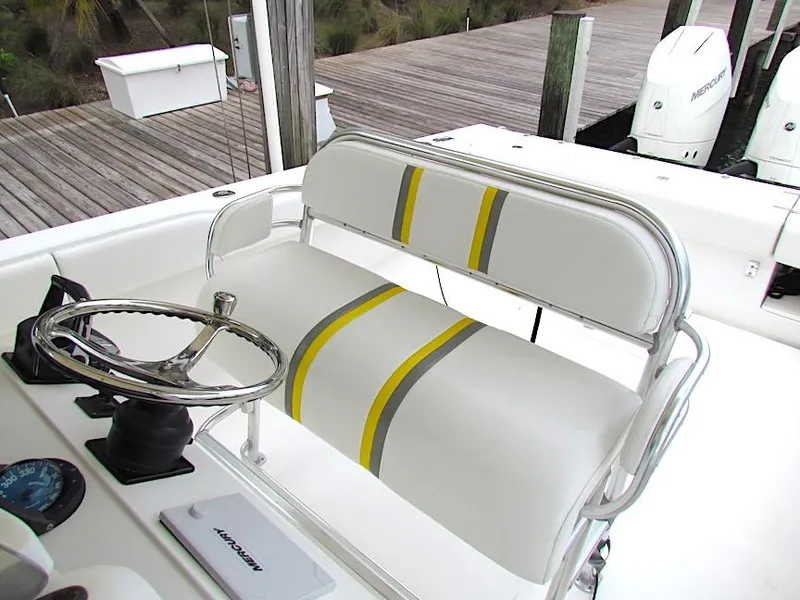 Slide: The Image of 2005 Venture 34 Open boat helm with striped seating and steering wheel. - 7