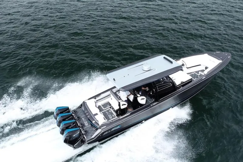 The Image of 2022 Nor-Tech 390 Sport boat cruising on open water, showcasing sleek design and powerful engines. - 0