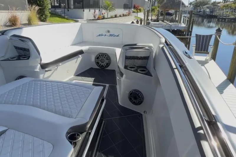 Slide: The Image of 2022 Nor-Tech 390 Sport boat interior with luxurious seating and modern design. - 12