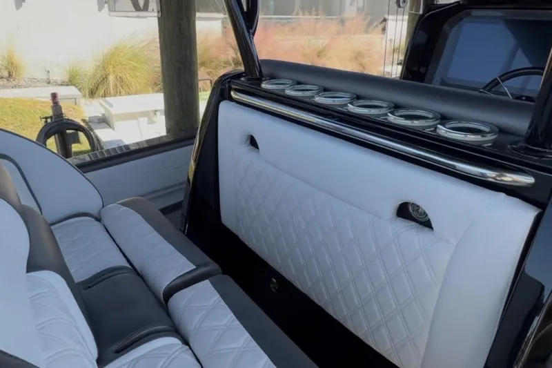 Slide: The Image of Luxurious interior of 2022 Nor-Tech 390 Sport boat with white quilted seating. - 13