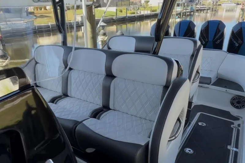 Slide: The Image of 2022 Nor-Tech 390 Sport boat interior with luxurious seating and modern design. - 16