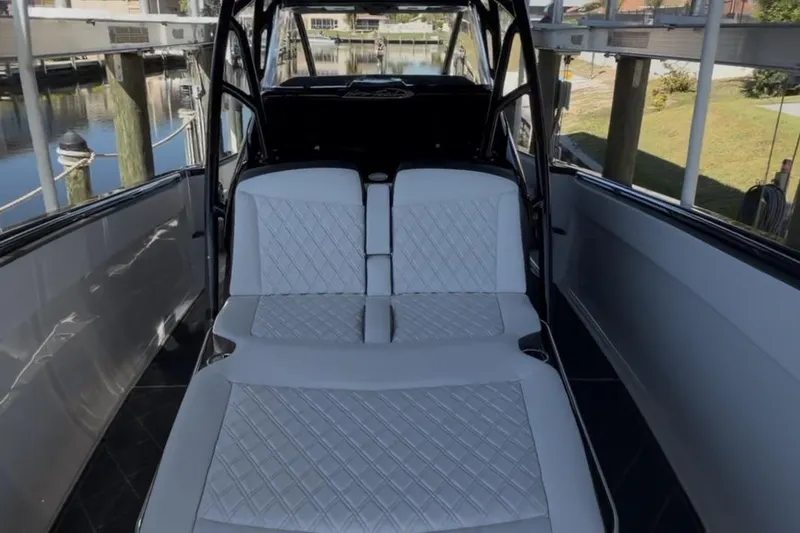 Slide: The Image of 2022 Nor-Tech 390 Sport boat interior with white quilted seating. - 18