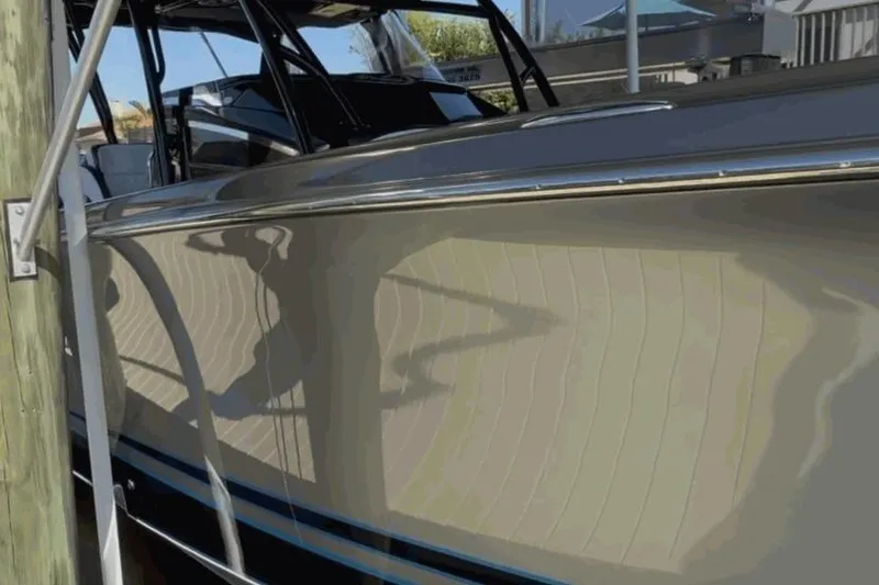 Slide: The Image of 2022 Nor-Tech 390 Sport boat docked, showcasing sleek design and polished exterior. - 23