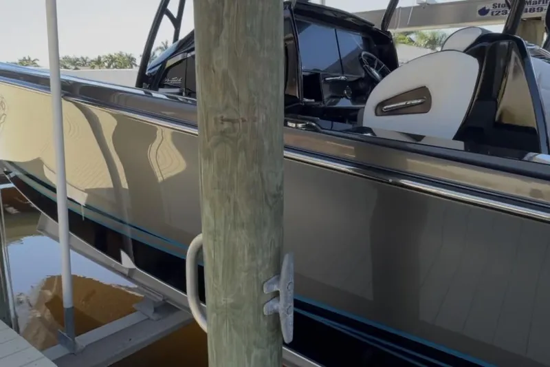 Slide: The Image of 2022 Nor-Tech 390 Sport boat docked, showcasing sleek design and luxurious interior. - 6