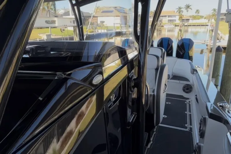 Slide: The Image of 2022 Nor-Tech 390 Sport boat interior with sleek design and powerful engines. - 8
