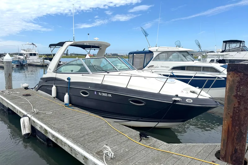 The Image of 2013 Monterey 260 SCR boat docked at marina under clear blue sky. - 1