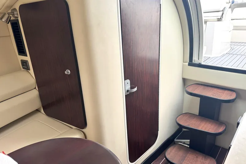 Slide: The Image of Interior of 2013 Monterey 260 SCR boat with wooden door and steps. - 10