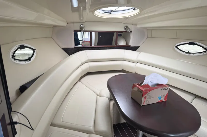 Slide: The Image of 2013 Monterey 260 SCR cabin interior with beige seating and oval table. - 11