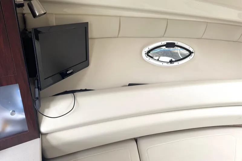 Slide: The Image of Interior of 2013 Monterey 260 SCR boat with TV and porthole window. - 12
