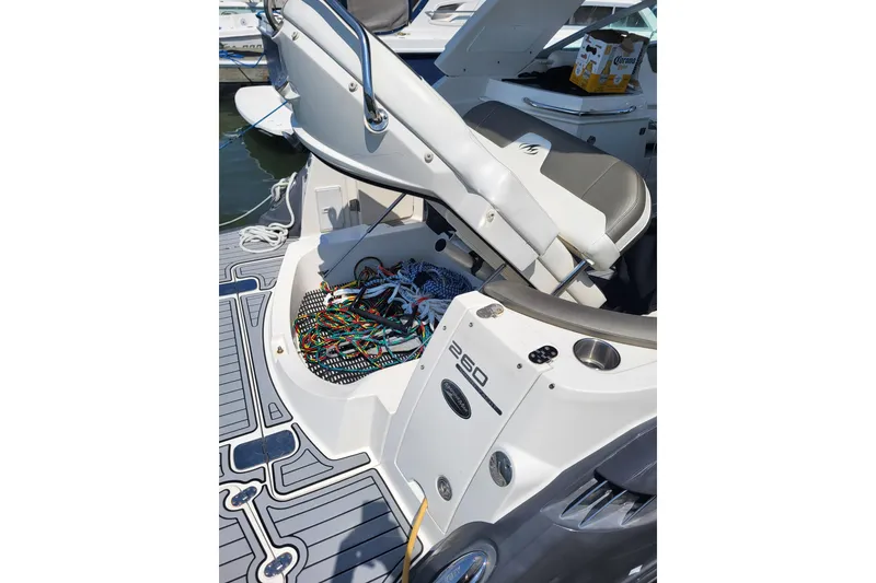 Slide: The Image of 2013 Monterey 260 SCR boat interior with open seat storage and colorful wiring. - 14