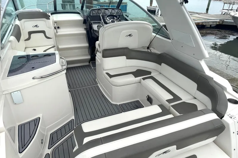 Slide: The Image of 2013 Monterey 260 SCR boat interior with sleek seating and modern dashboard. - 4