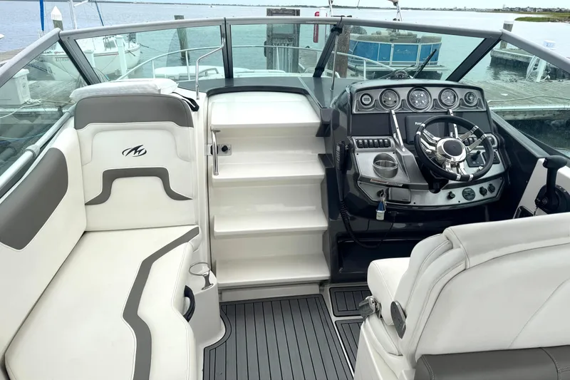 Slide: The Image of Interior of a 2013 Monterey 260 SCR boat with sleek dashboard and seating. - 6