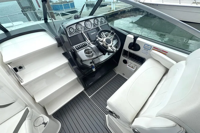 Slide: The Image of Cockpit of 2013 Monterey 260 SCR boat with steering wheel and seating. - 7