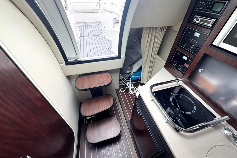 Slide: The Image of Interior of a 2013 Monterey 260 SCR boat with kitchenette and seating area. - 9