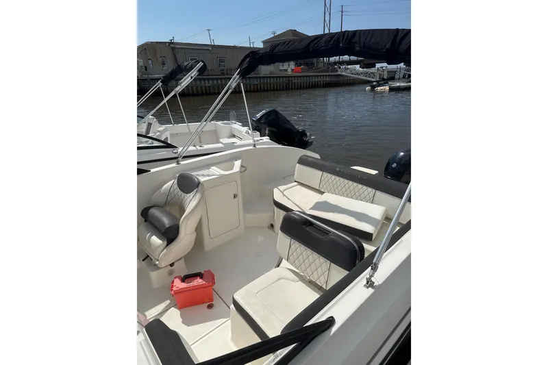 Slide: The Image of 2023 Bayliner DX 2200 boat interior with seating and water view. - 6