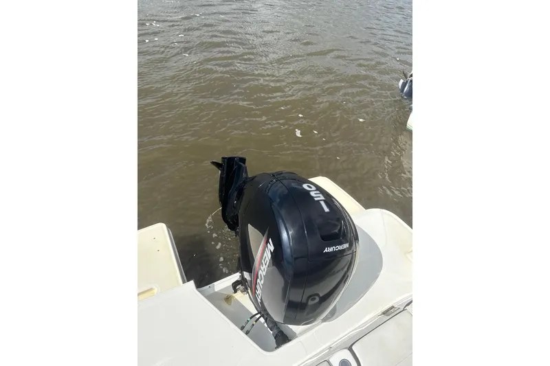Slide: The Image of 2023 Bayliner DX 2200 with Mercury 150 outboard engine on water. - 8