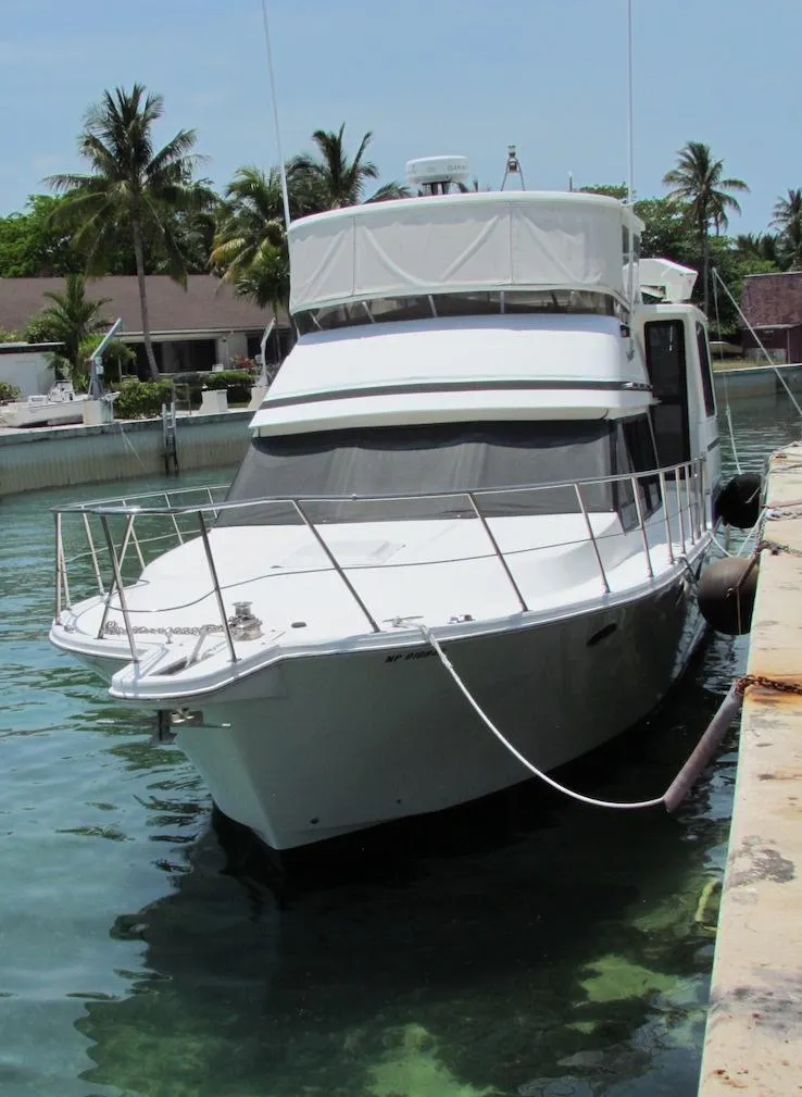 The Image of 1997 Hyatt 55 yacht docked in a tropical marina with palm trees. - 0
