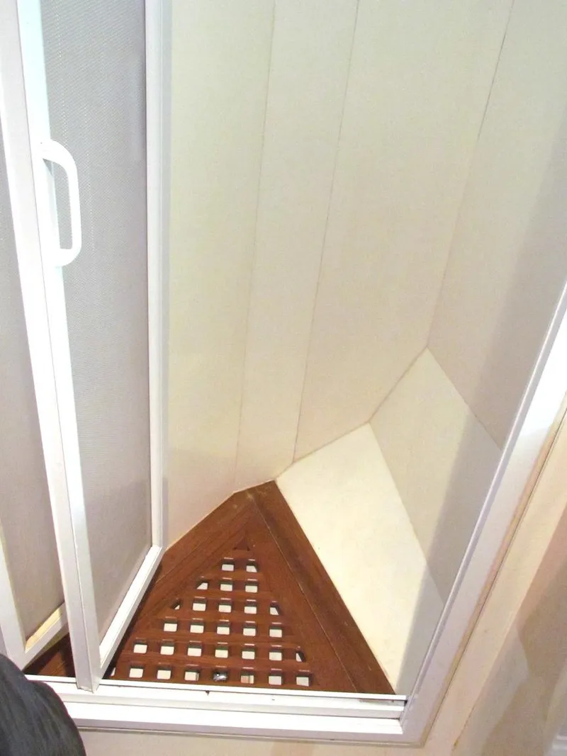 Slide: The Image of Small shower with wooden floor in a 1997 Hyatt 55 model. - 15