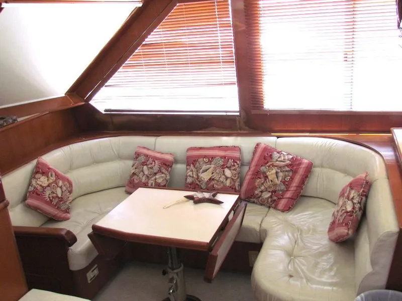 Slide: The Image of Luxurious 1997 Hyatt 55 yacht interior with plush seating and decorative pillows. - 17
