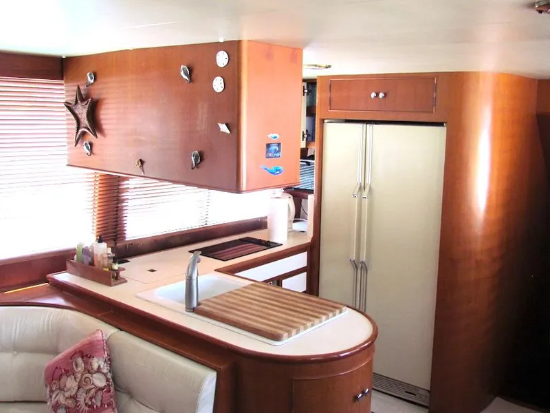Slide: The Image of Luxurious 1997 Hyatt 55 yacht interior with modern kitchen and elegant wood finishes. - 20
