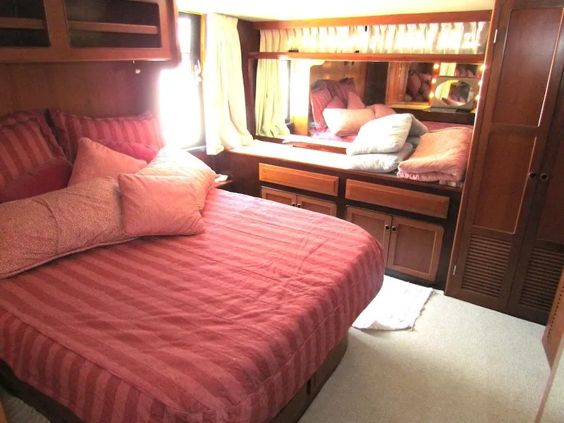 Slide: The Image of Cozy bedroom with pink bedding in a 1997 Hyatt 55 yacht. - 23