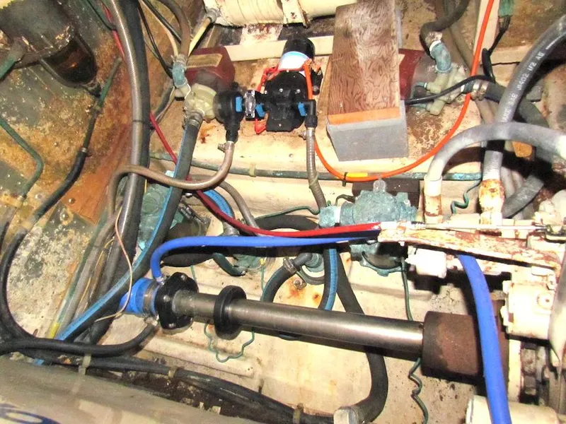 Slide: The Image of Engine room of a 1997 Hyatt 55 yacht with visible pipes and machinery. - 32