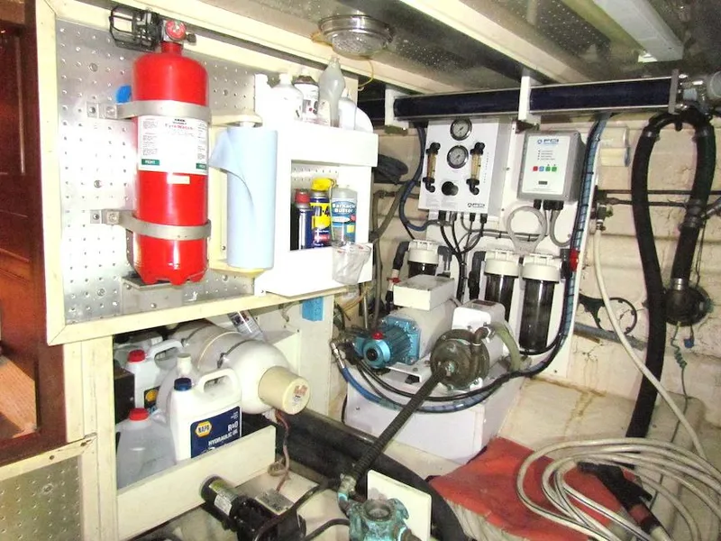 Slide: The Image of Engine room of a 1997 Hyatt 55 yacht with equipment and fire extinguisher. - 33