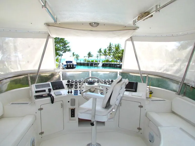 Slide: The Image of Cockpit of 1997 Hyatt 55 yacht with steering wheel, controls, and ocean view. - 5
