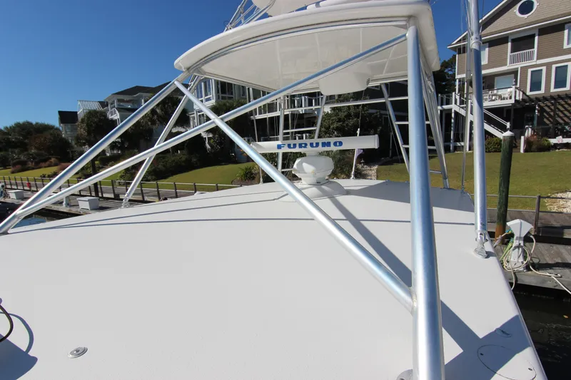 Slide: The Image of 2008 Bertram 360 boat with Furuno radar, docked near waterfront homes. - 14
